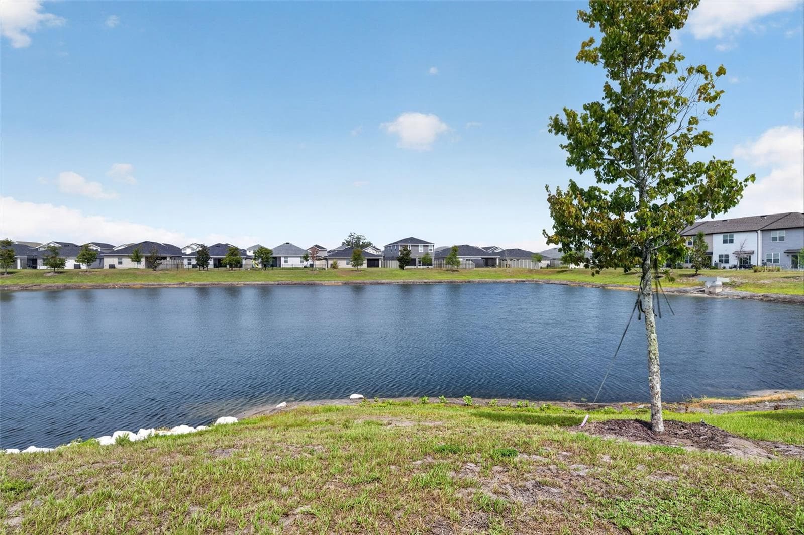 Pond View from Living room and front door - 381 GRAND PINE LN, ST CLOUD