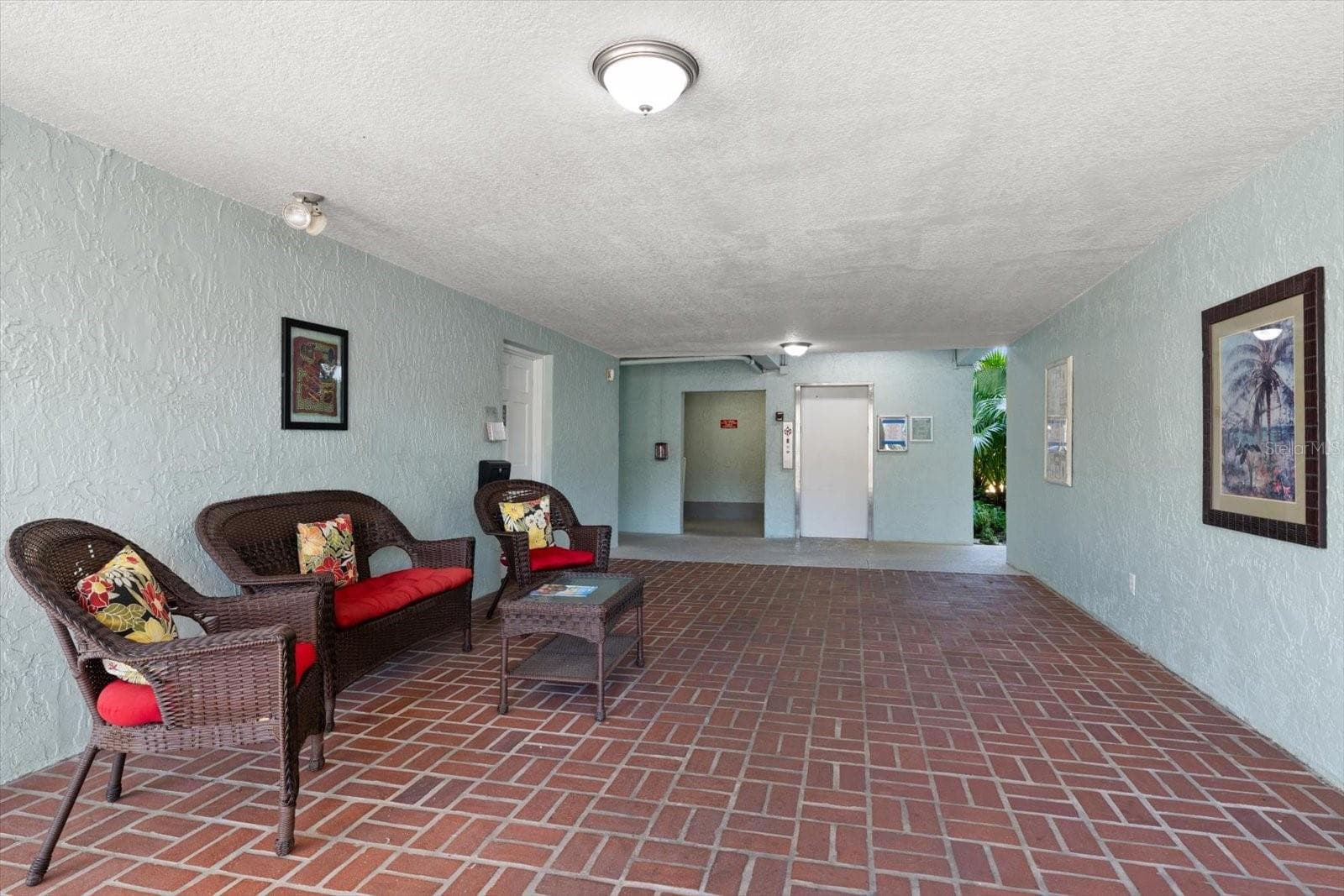 Ground floor building entrance to elevator, bike storage and laundry facility - 1706 BELLEAIR FOREST DR #238, BELLEAIR
