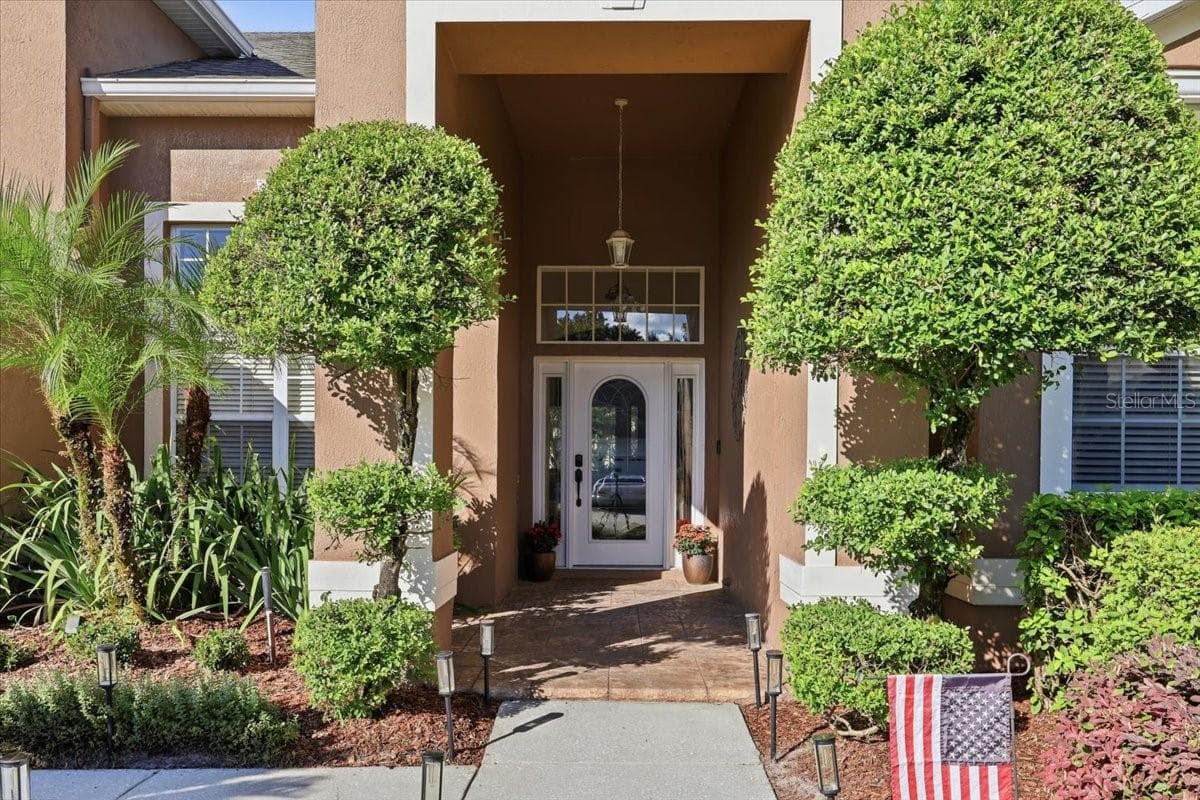 Manicured landscaping, covered front entry. - 2631 TREYMORE DR, ORLANDO