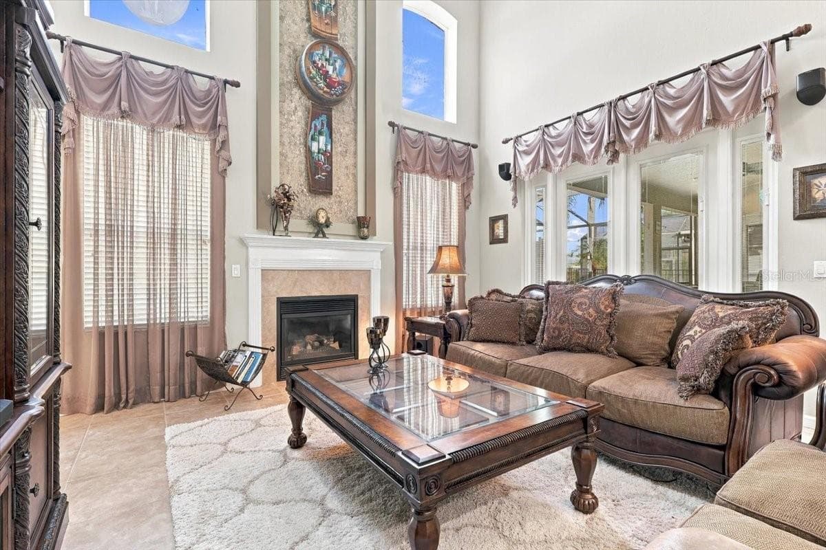 Two story living room is anchored by the fireplace feature wall. - 2631 TREYMORE DR, ORLANDO