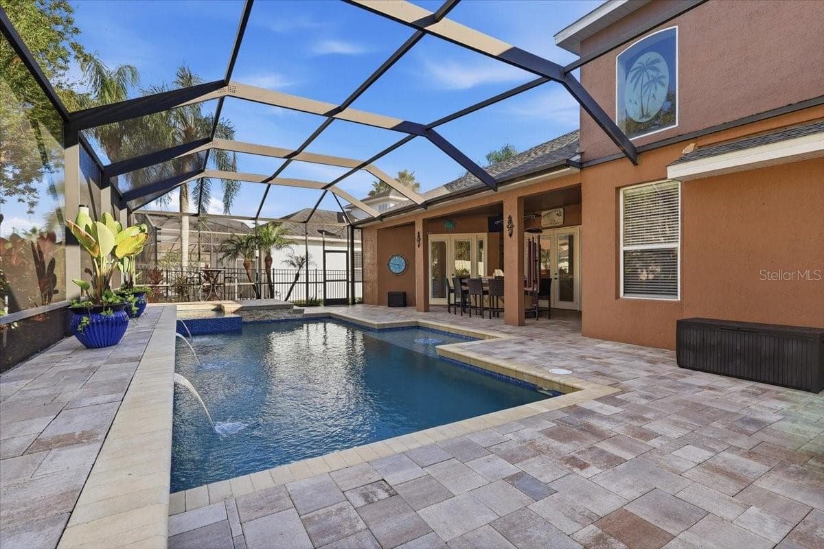 Covered lanai overlooks the private screened pool. - 2631 TREYMORE DR, ORLANDO