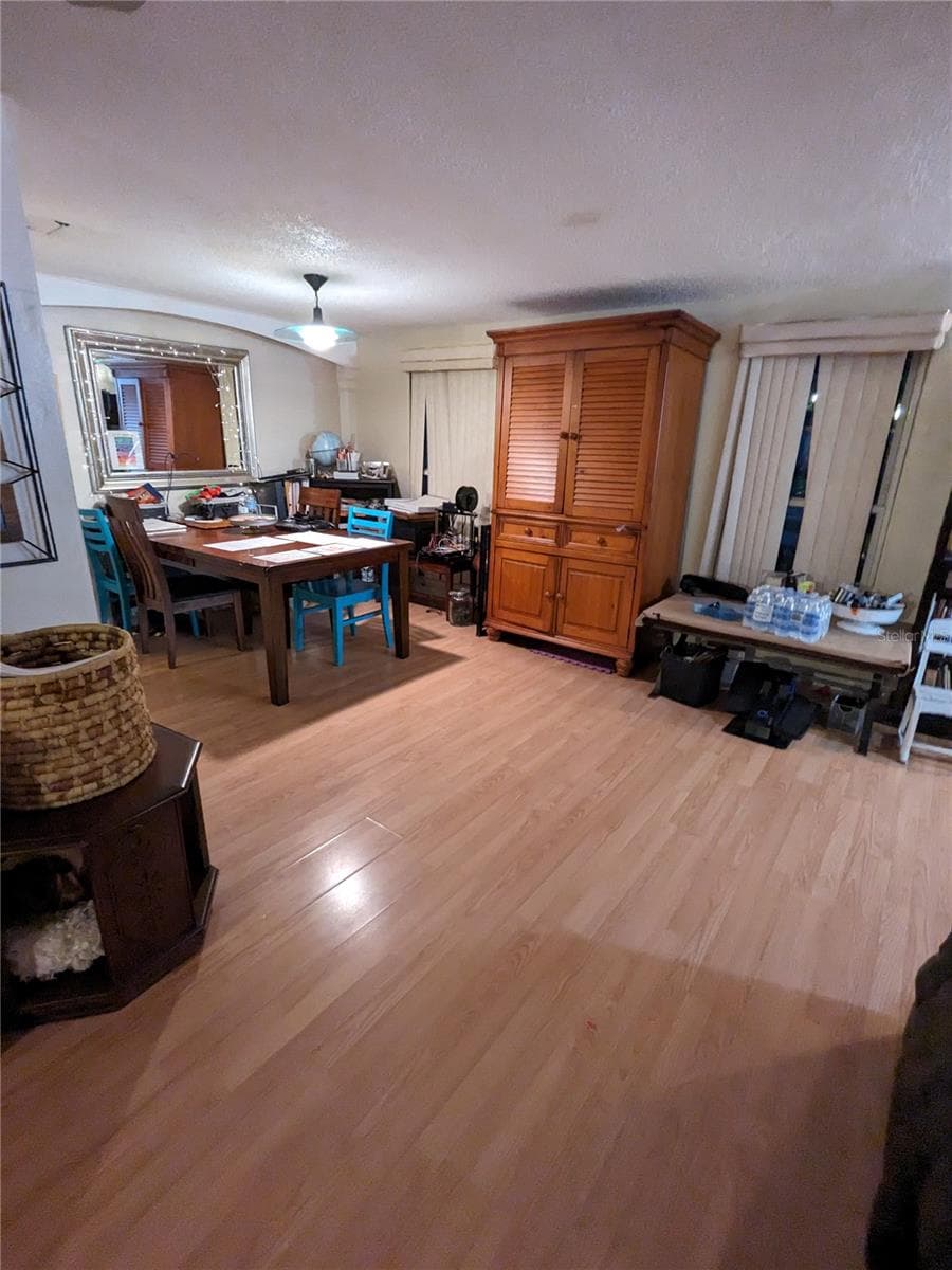 VIEW FROM LIVING ROOM TO "L" DINING ROOM AND FRONT WINDOWS - 3937 SAIL DR, NEW PORT RICHEY