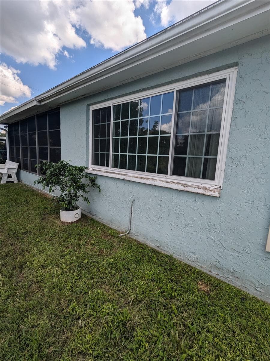 WINDOWS FROM EXTENDED LIVING AREA IN FOREGROUND AND SCREENED AND VINYL WINDOWED LANAI IN BACKGROUND - 3937 SAIL DR, NEW PORT RICHEY