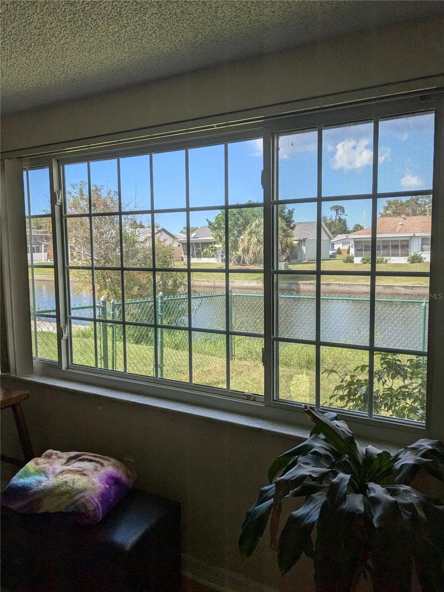 FABULOUS VIEW OF BACKYARD & FENCE WITH CANAL IN BACKGROUND - 3937 SAIL DR, NEW PORT RICHEY