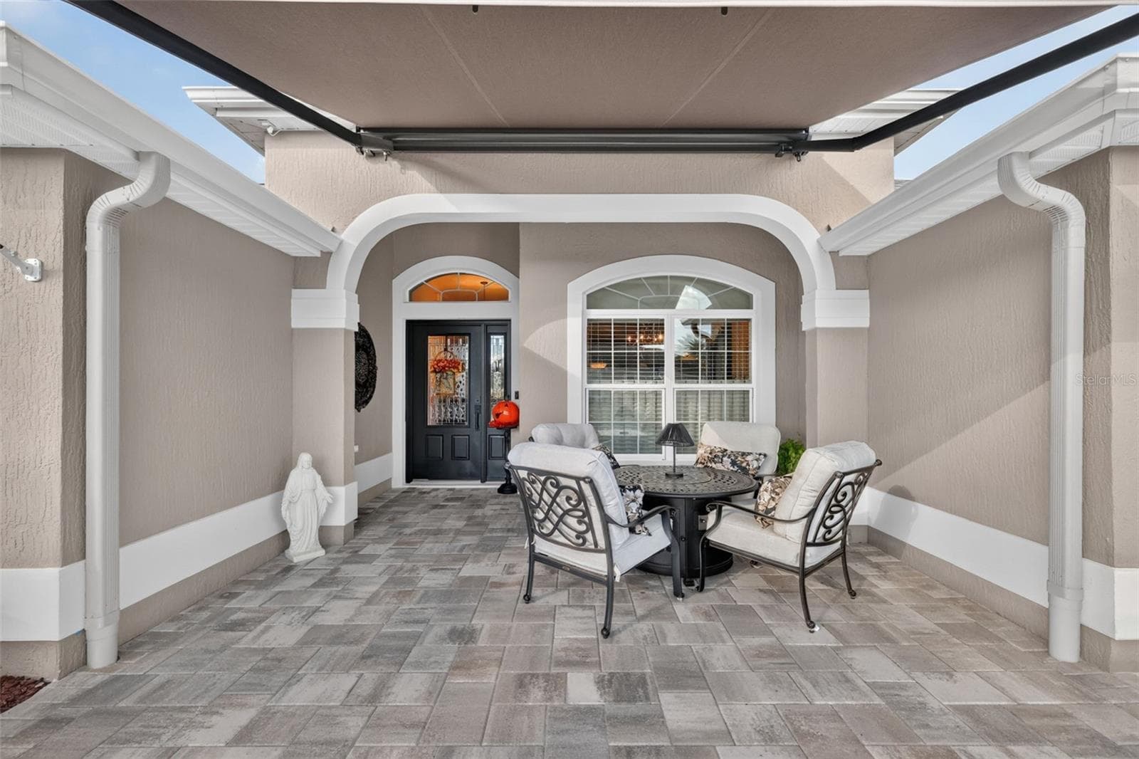 Front Entry with Paver Patio and Remote-Controlled Awning - 1793 WAX BERRY CT, THE VILLAGES