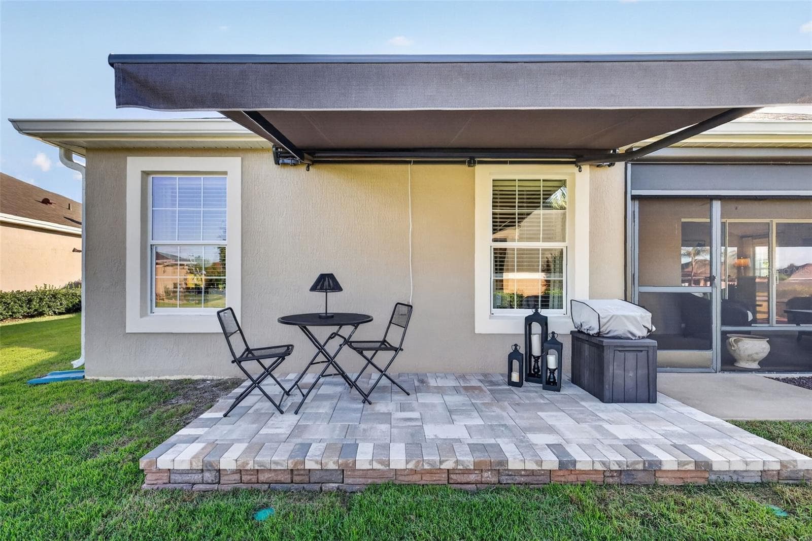 Side Paver Patio with Remote-Controlled Awning - 1793 WAX BERRY CT, THE VILLAGES