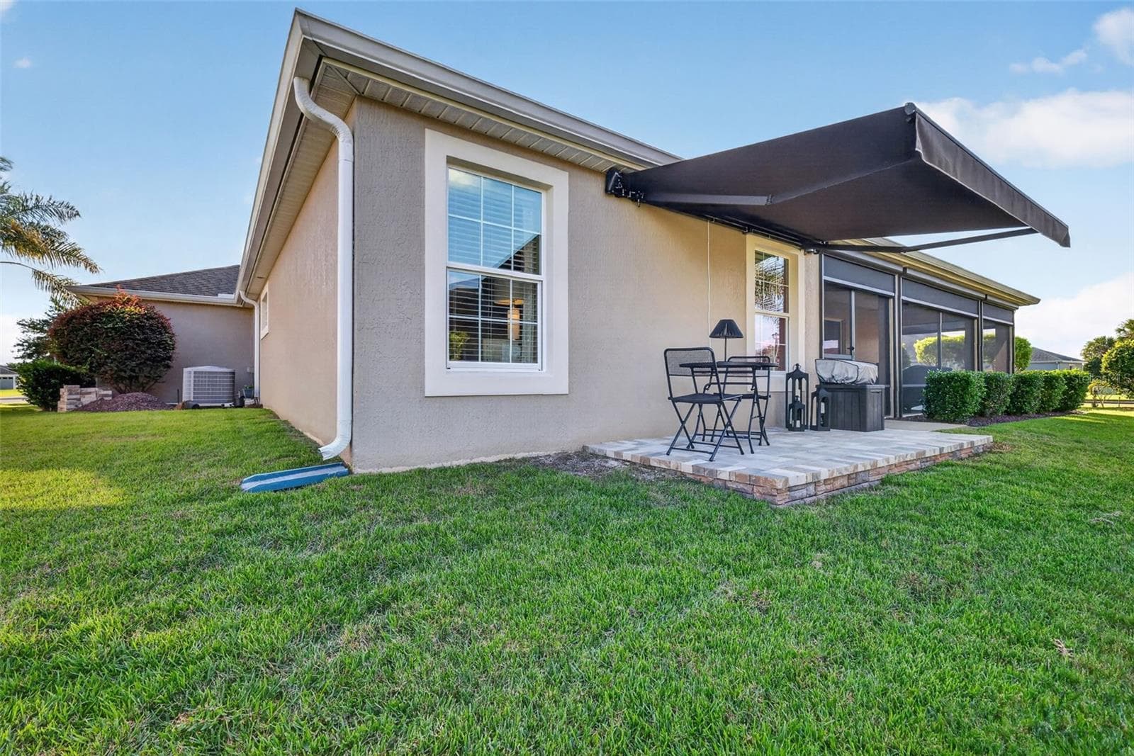 Side Paver Patio with Remote-Controlled Awning - 1793 WAX BERRY CT, THE VILLAGES