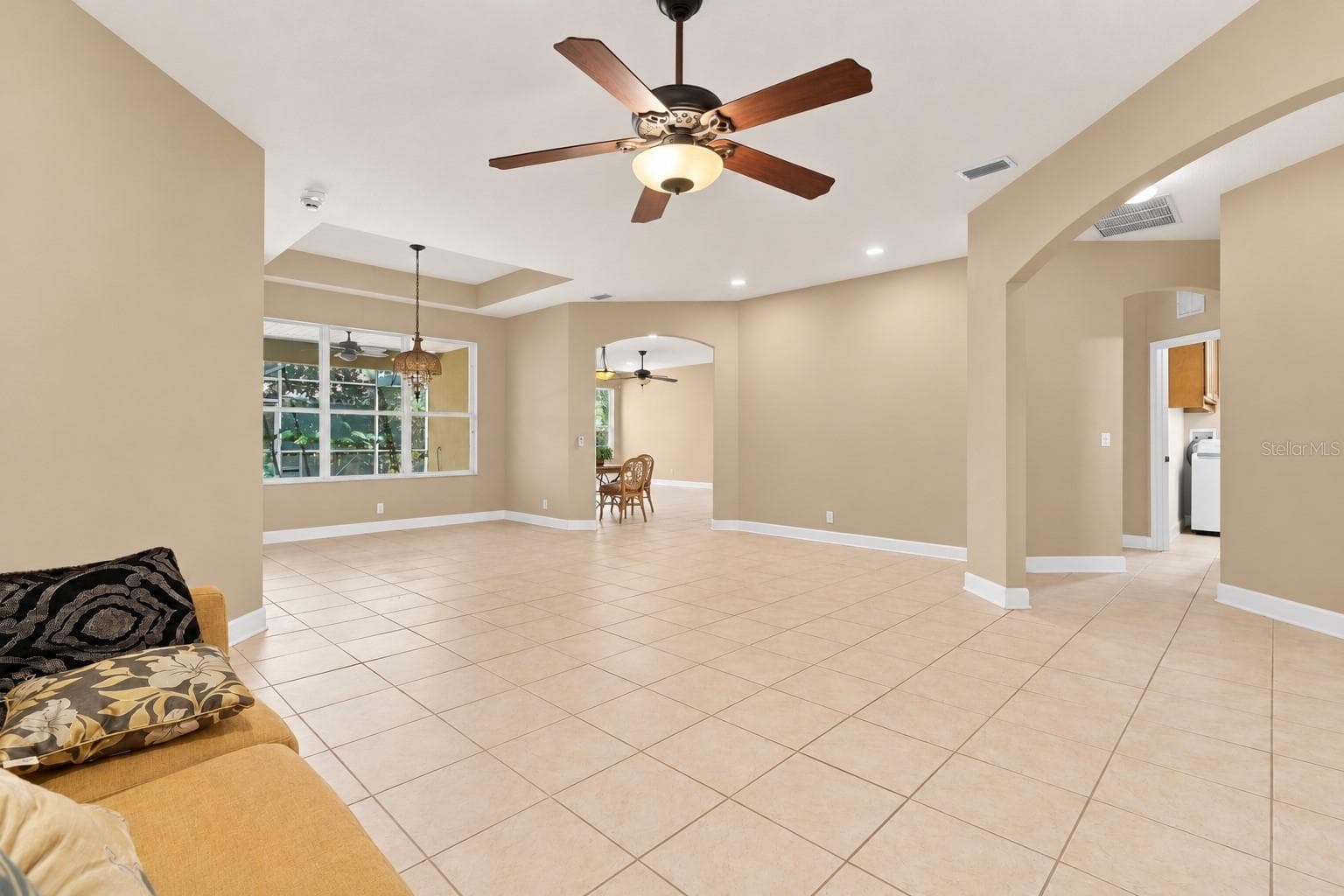 LIVING ROOM - wall color is accessible beige Sherwin Williams - 1609 VICTORIA GARDENS DR, DELAND