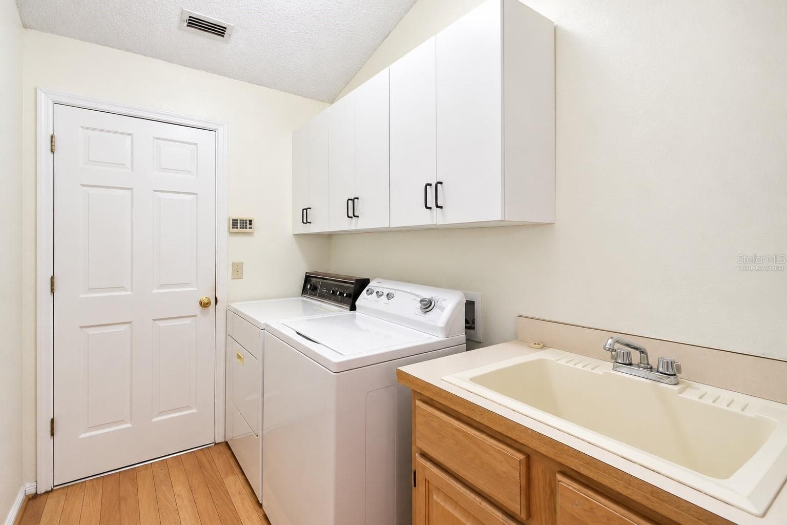 VIRTUALLY STAGED LAUNDRY ROOM - 3924 LAKE MIRAGE BLVD, ORLANDO