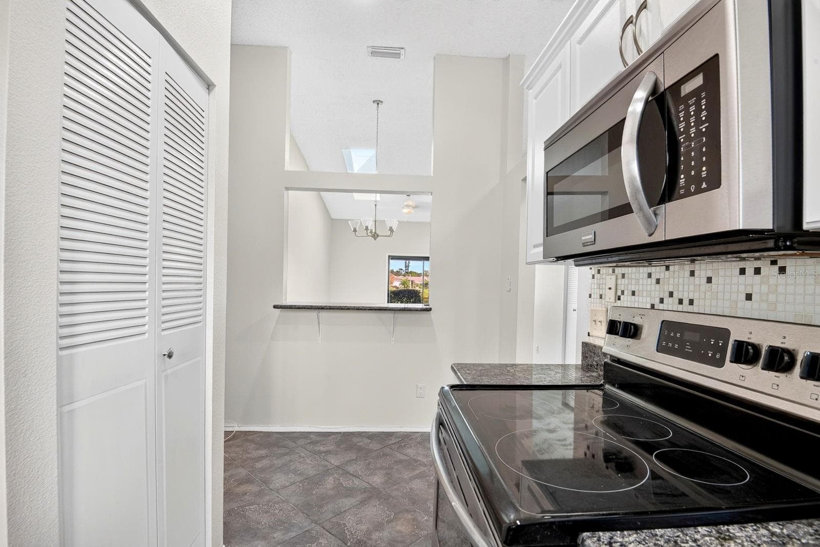 Facing into Breakfast nook and dining area - 2930 64TH ST W #130, BRADENTON