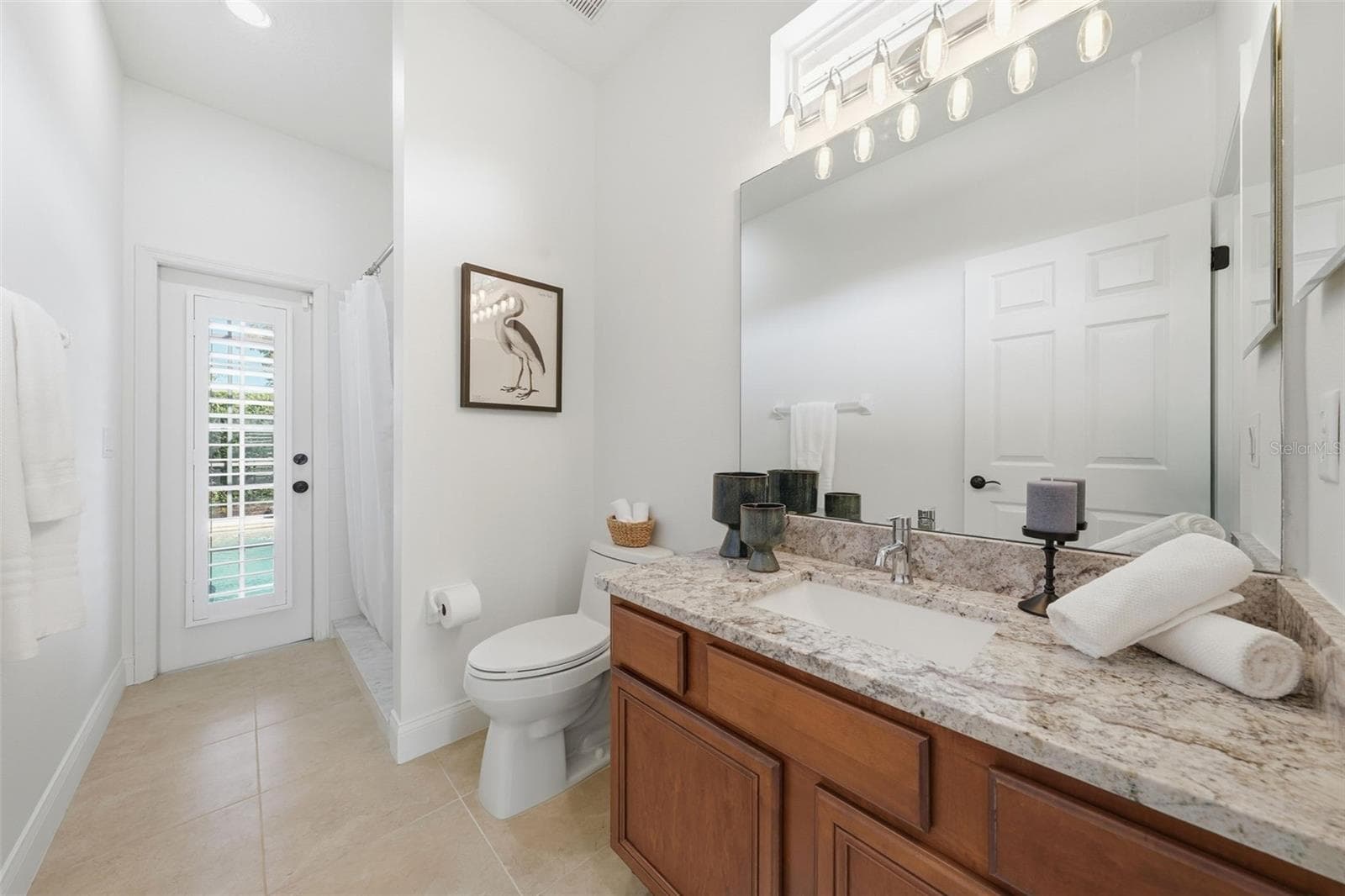 3RD BATHROOM (POOL BATH) WITH DOOR OUT TO THE POOL AND FULL SHOWER - 13850 BLUEWATER CIR, ORLANDO
