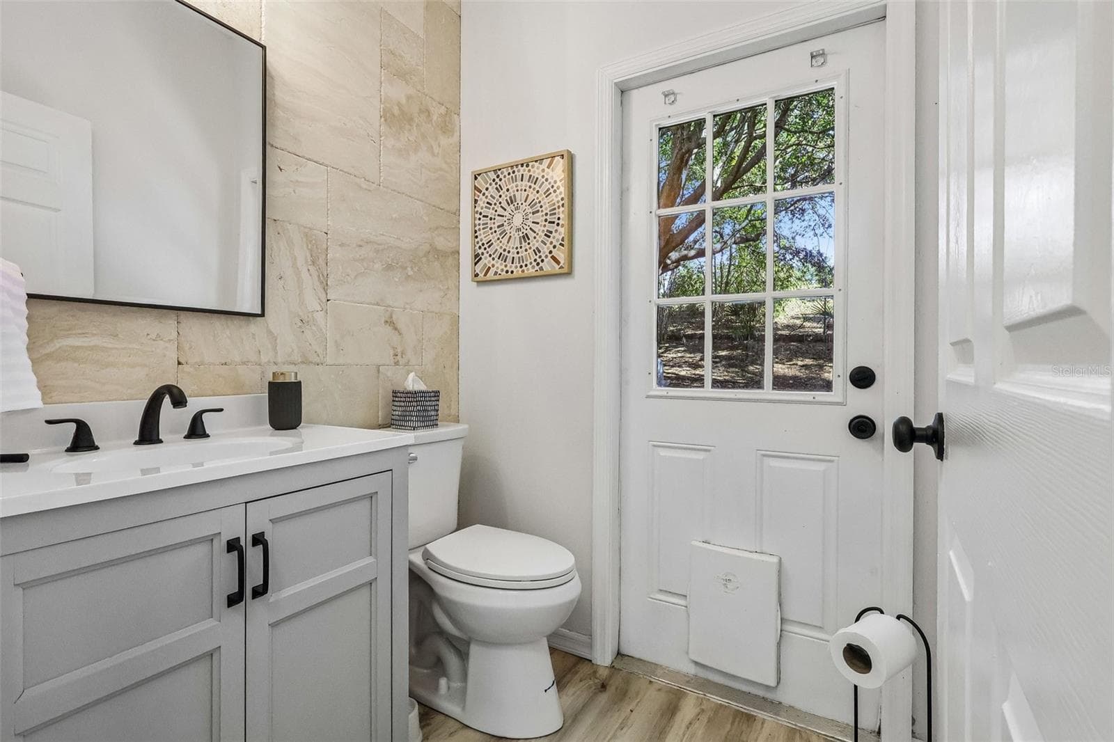Powder room facing the backyard. Great for outdoor play then clean up here before dinner. - 1305 WINDY BLUFF DR, MINNEOLA