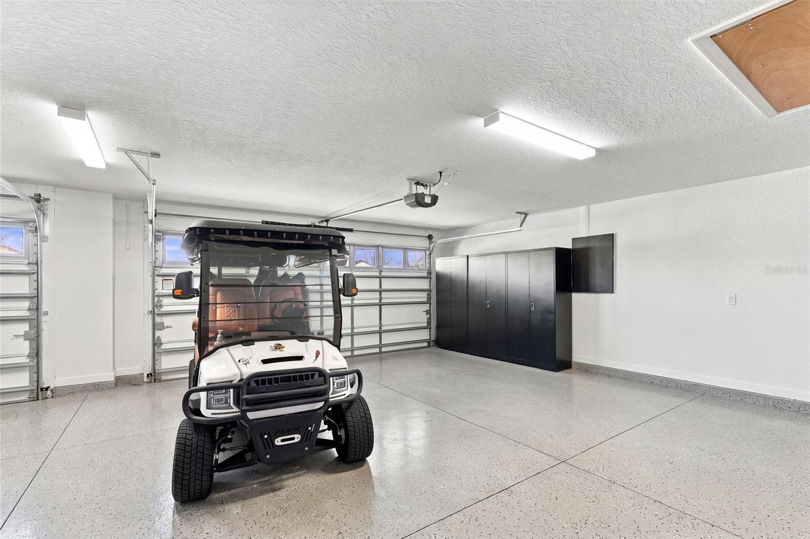 Garage's 2 Car area with a glimpse of Golf Cart side to left - 614 LAKE CREEK CIR, THE VILLAGES