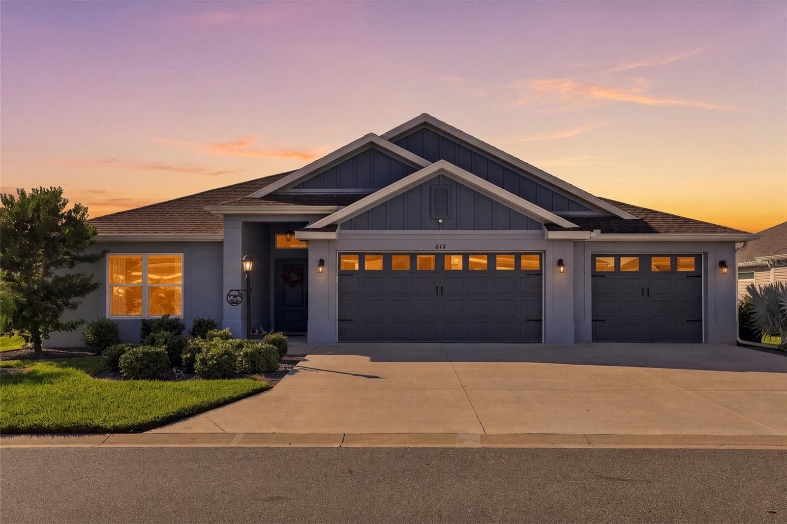 Front with Twilight - 614 LAKE CREEK CIR, THE VILLAGES
