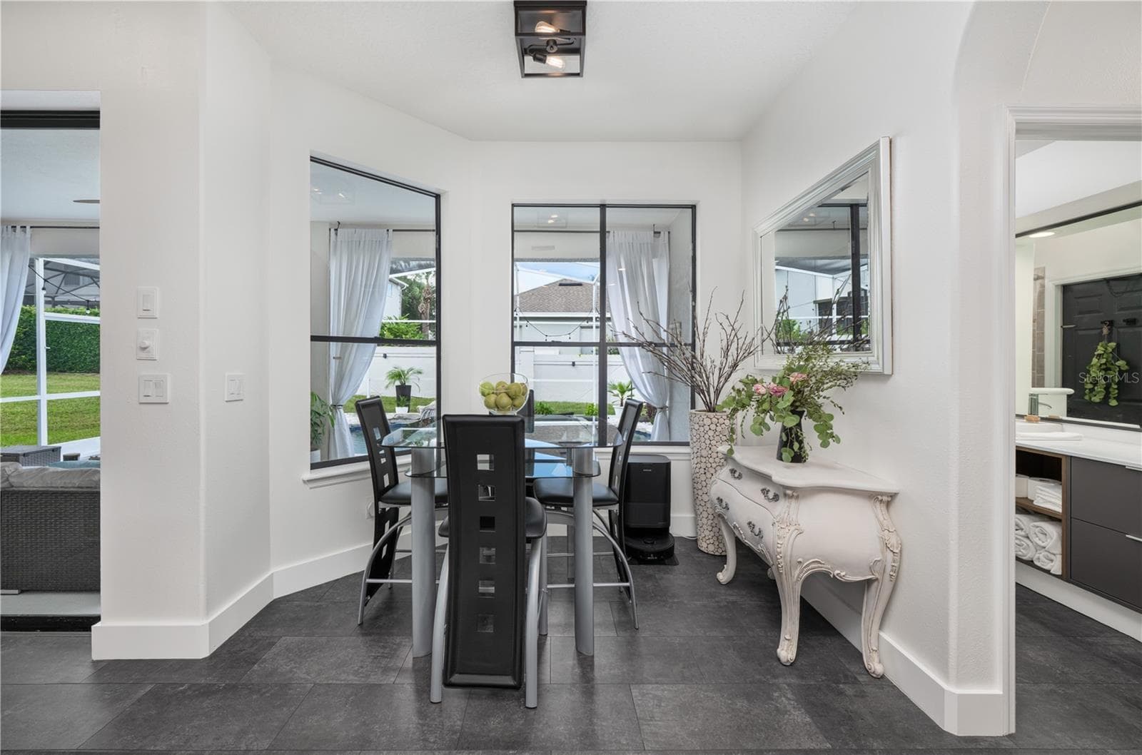 Bright and inviting breakfast nook with a picturesque view of the pool. - 1854 VISTA ROYALE BLVD, ORLANDO