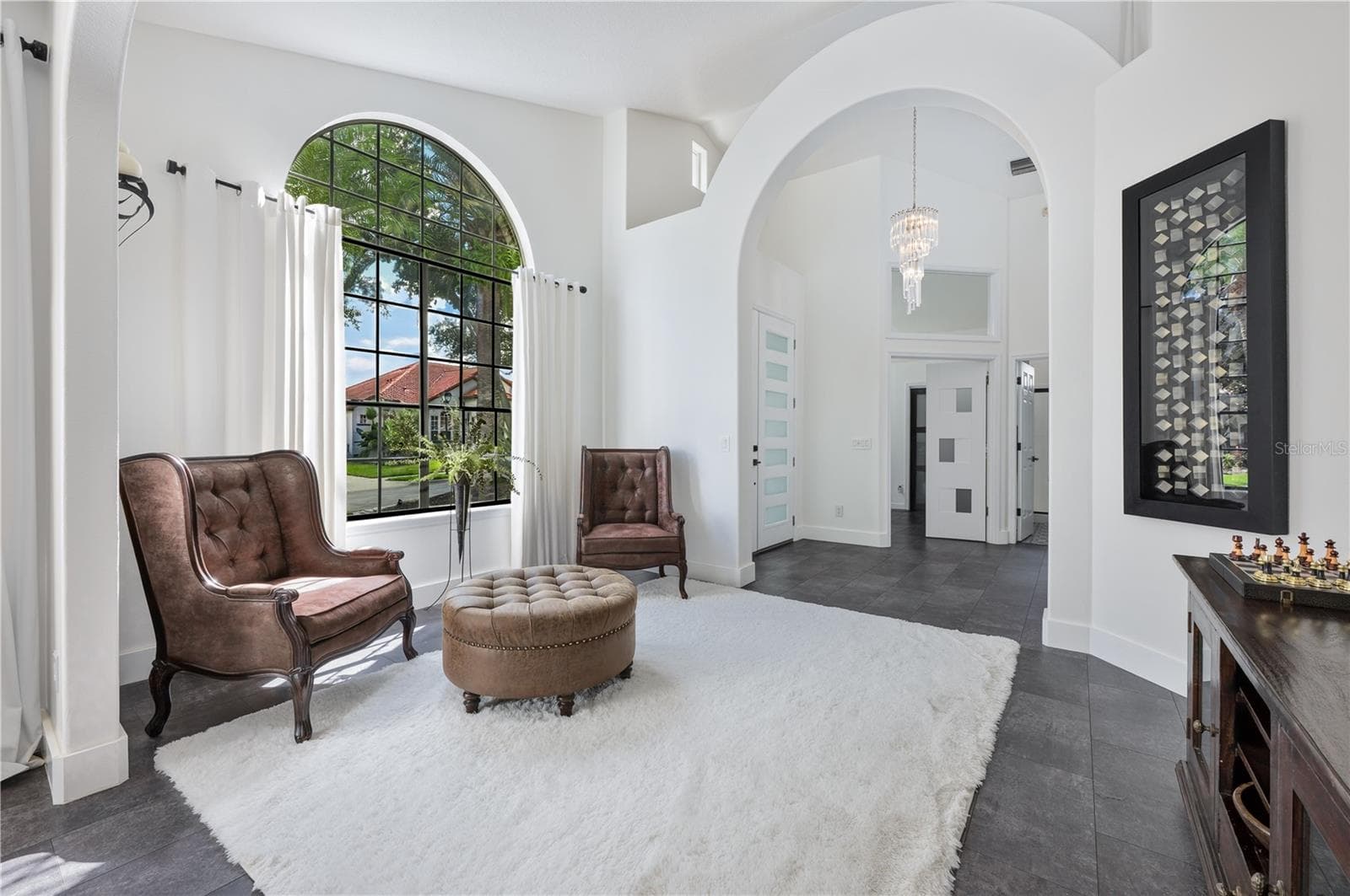 This formal living room is a standout feature of the home, providing an elegant space for relaxation and the perfect backdrop for a holiday tree. - 1854 VISTA ROYALE BLVD, ORLANDO
