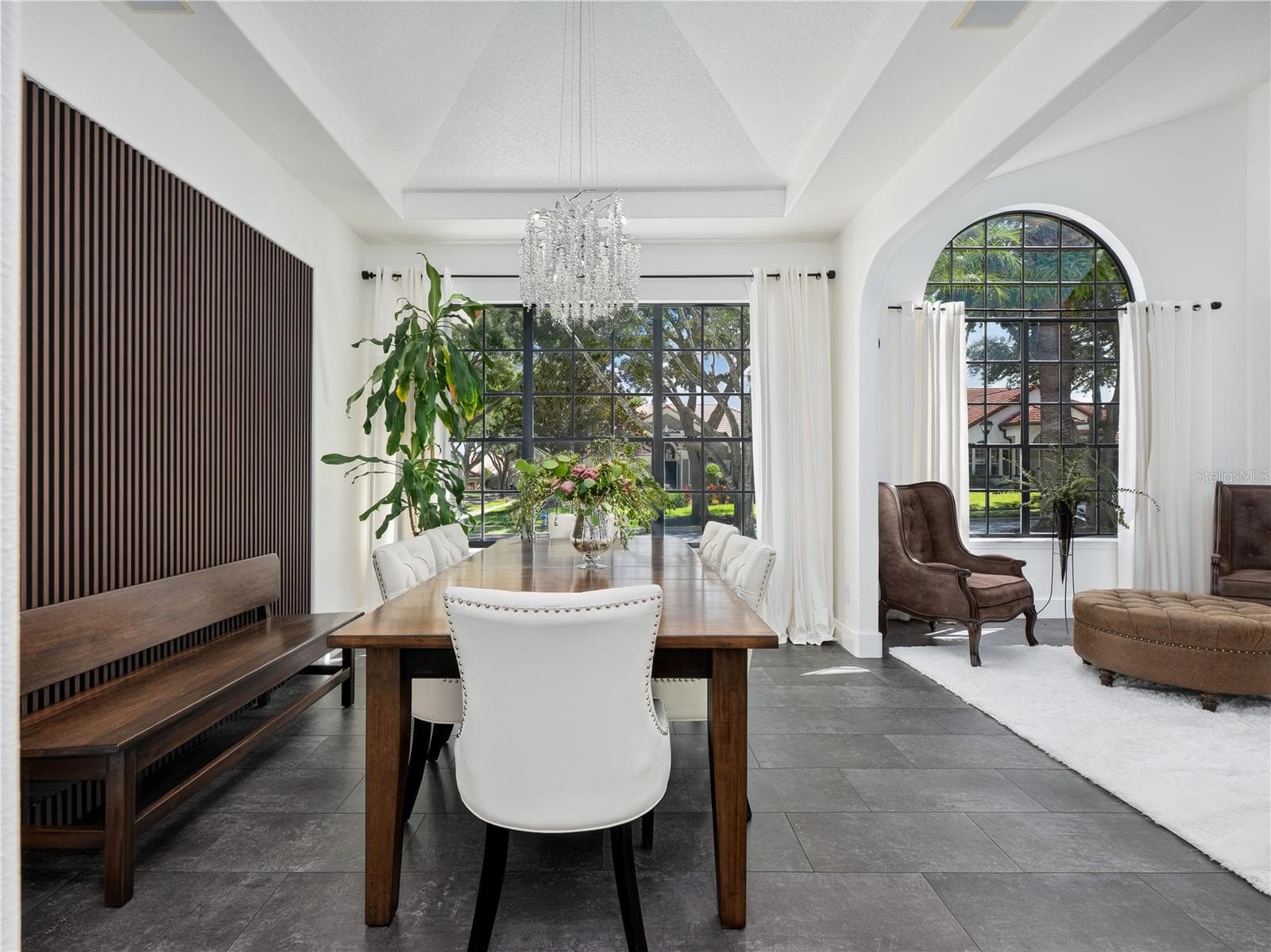 Architectural wood panels serve as the perfect backdrop for this stunning dining room. - 1854 VISTA ROYALE BLVD, ORLANDO