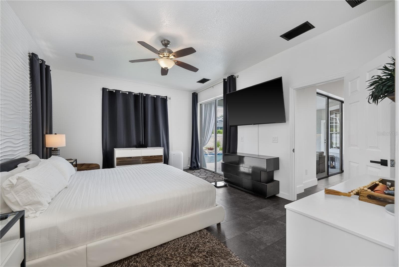 Spacious primary bedroom with a scenic view of the pool. - 1854 VISTA ROYALE BLVD, ORLANDO