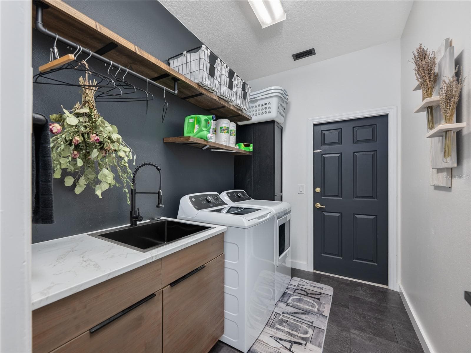Beautiful laundry room featuring built-in shelving and a functional utility sink. - 1854 VISTA ROYALE BLVD, ORLANDO