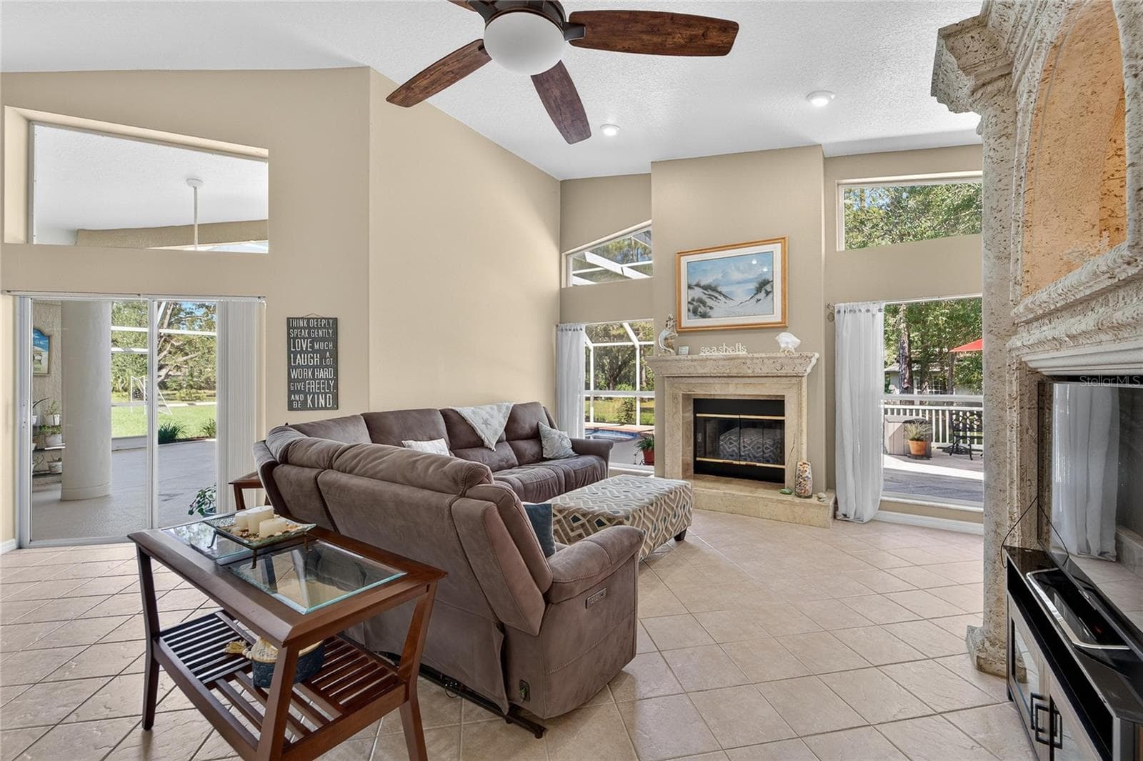 Family room is open to the kitchen, overlooks the pool and has a wood burning fireplace - 0 LINDENHURST DR, WESLEY CHAPEL