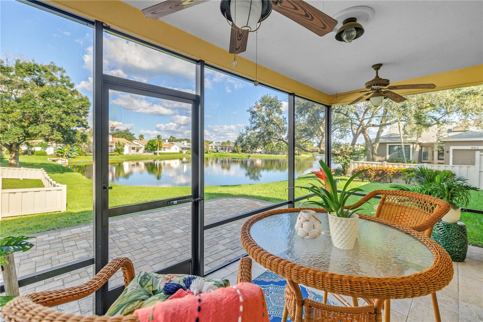 This covered, screened patio provides an ideal setting for enjoying scenic lake views and local wildlife, whether you are relaxing with a beverage or entertaining guests. - 868 GLADES CT NE, ST PETERSBURG