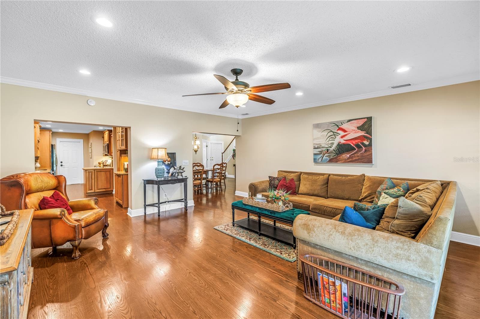 Spacious bonus family room (17x18) designed for effortless entertaining, featuring hurricane-rated sliders that offer seamless access to the screened porch and raised back patio. - 868 GLADES CT NE, ST PETERSBURG