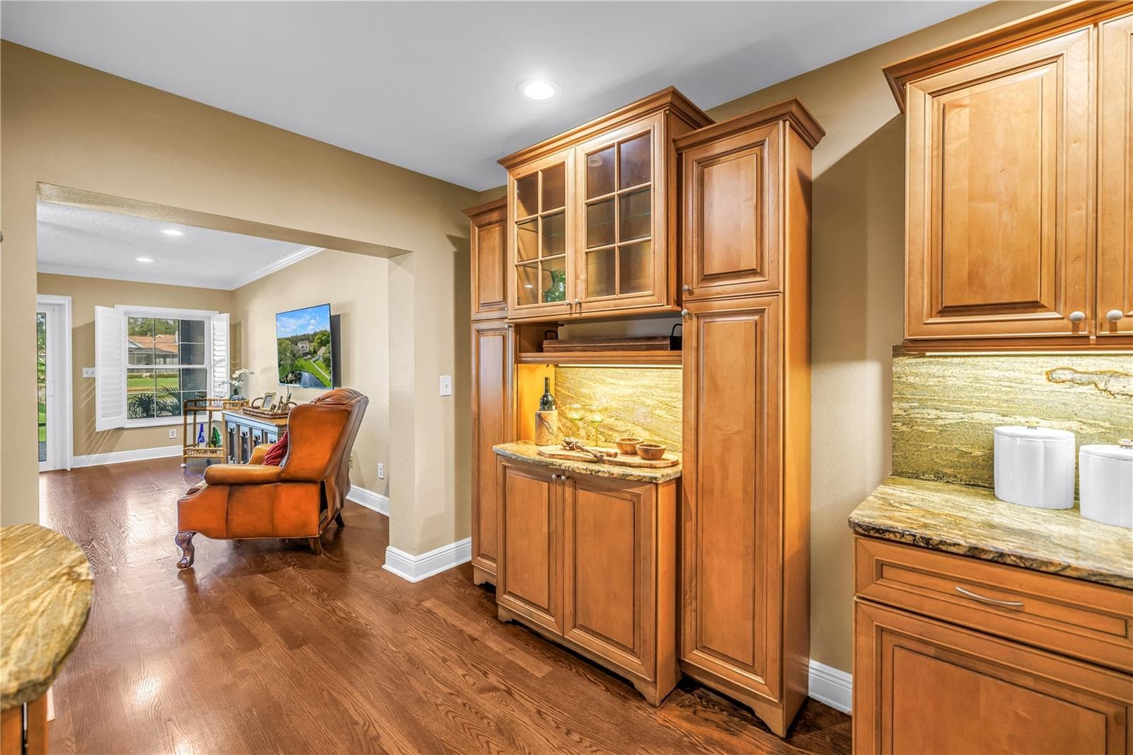 This space features a matching bar area for charcuterie or appetizers, positioned opposite the dedicated beverage station. The design includes matching granite countertops and a coordinated backsplash. The room is fully equipped and staged for holiday entertaining. - 868 GLADES CT NE, ST PETERSBURG