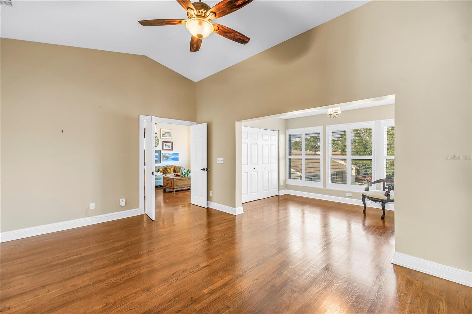 This secondary view showcases the primary suite and adjacent bonus area, highlighting the luxury French door entrance. - 868 GLADES CT NE, ST PETERSBURG
