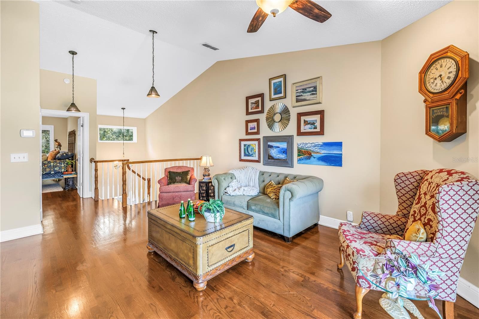 The upstairs bonus space features an open, vaulted ceiling, accessible via a custom-crafted staircase. - 868 GLADES CT NE, ST PETERSBURG
