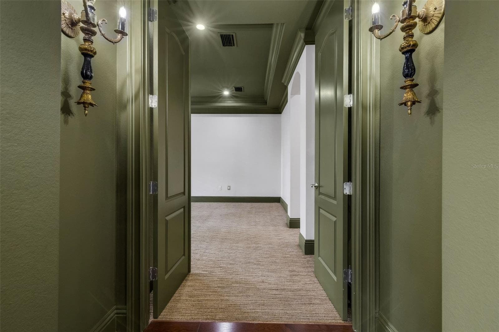 The primary suite is on the first floor and secluded away through double doors. - 2734 BELLERIVE DR, LAKELAND