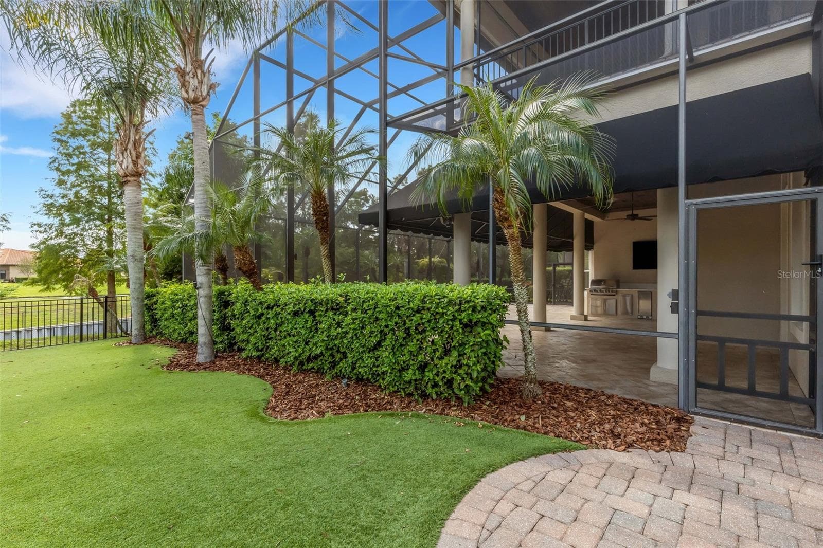Step outside the enclosure to the fenced in play or dog area . . . - 2734 BELLERIVE DR, LAKELAND