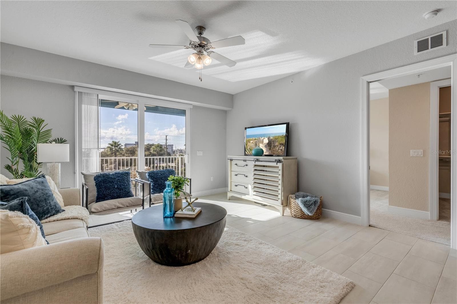 Living Room with large slider to the back patio - 1 RIVERWALK DR #303, NEW SMYRNA BEACH