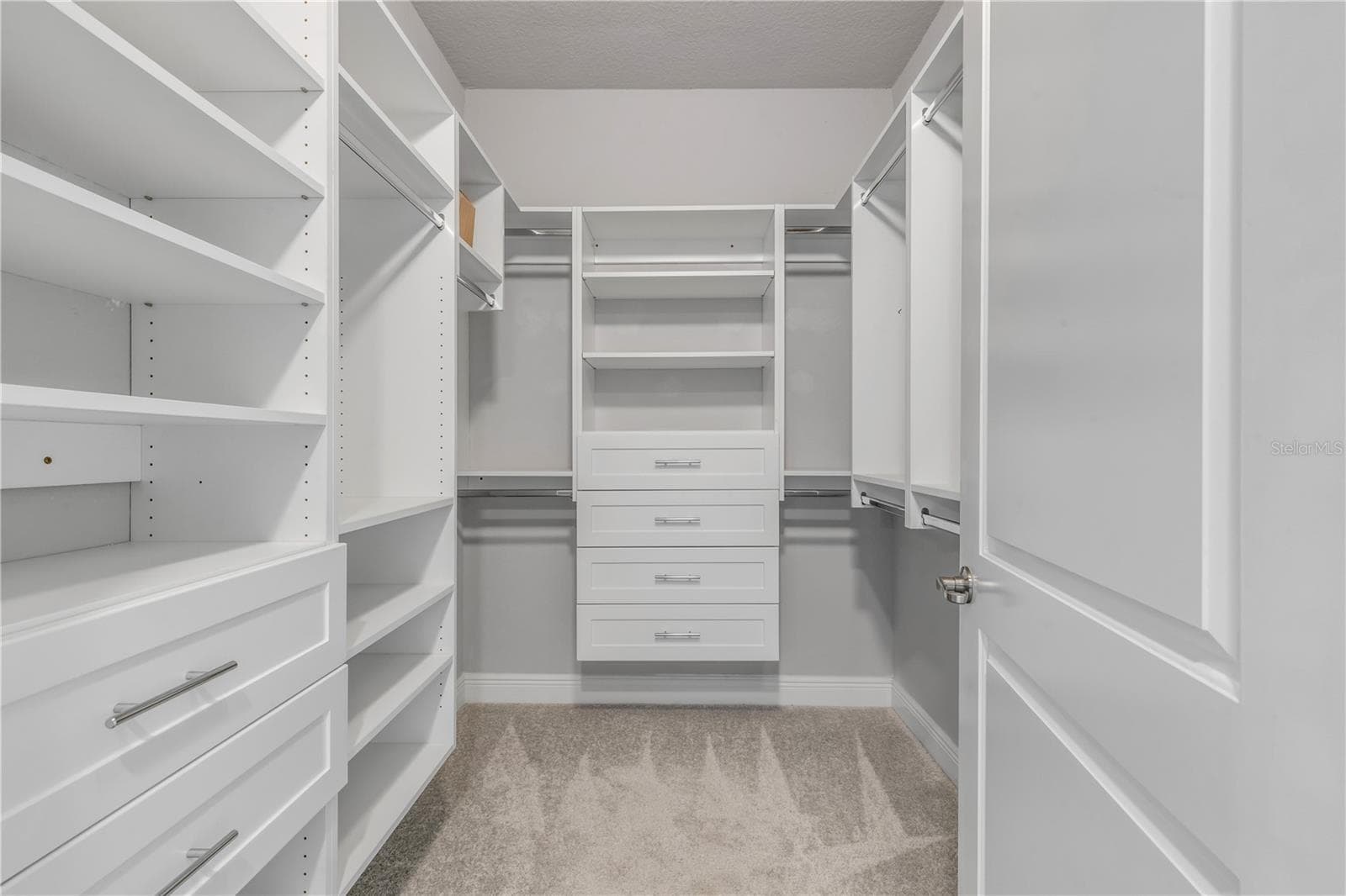 Primary bedroom walk in closet - 1 RIVERWALK DR #303, NEW SMYRNA BEACH