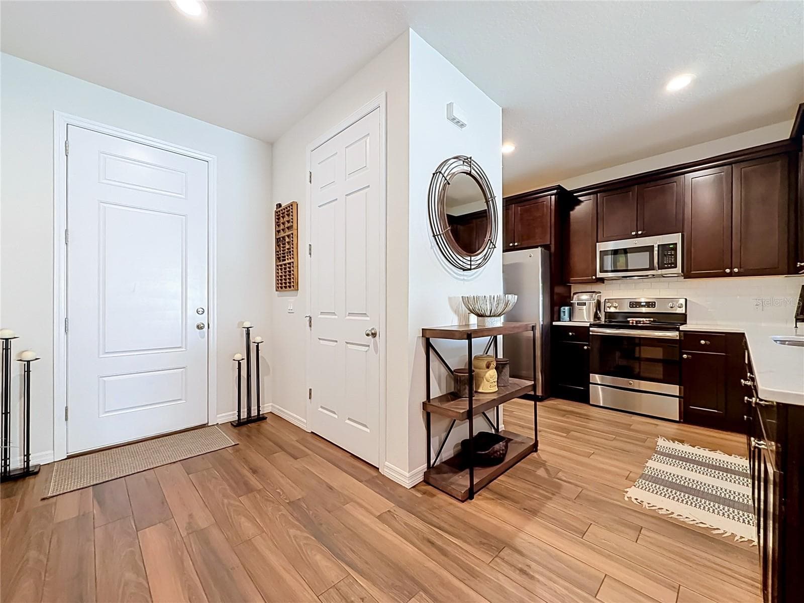 Step inside to discover a spacious OPEN FLOOR PLAN with soaring ceilings and beautiful WOOD-LOOK TILE flooring throughout the downstairs living areas. - 2270 MONTVIEW DR, CLEARWATER