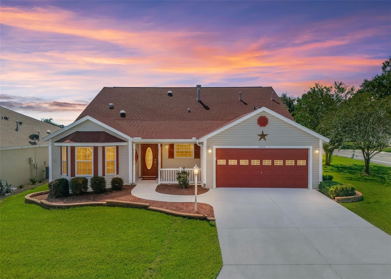 Twilight View with Decorative Pavers, Red Gravel and Low-Maintenance Shrubs. - 2762 MORVEN PARK WAY, THE VILLAGES