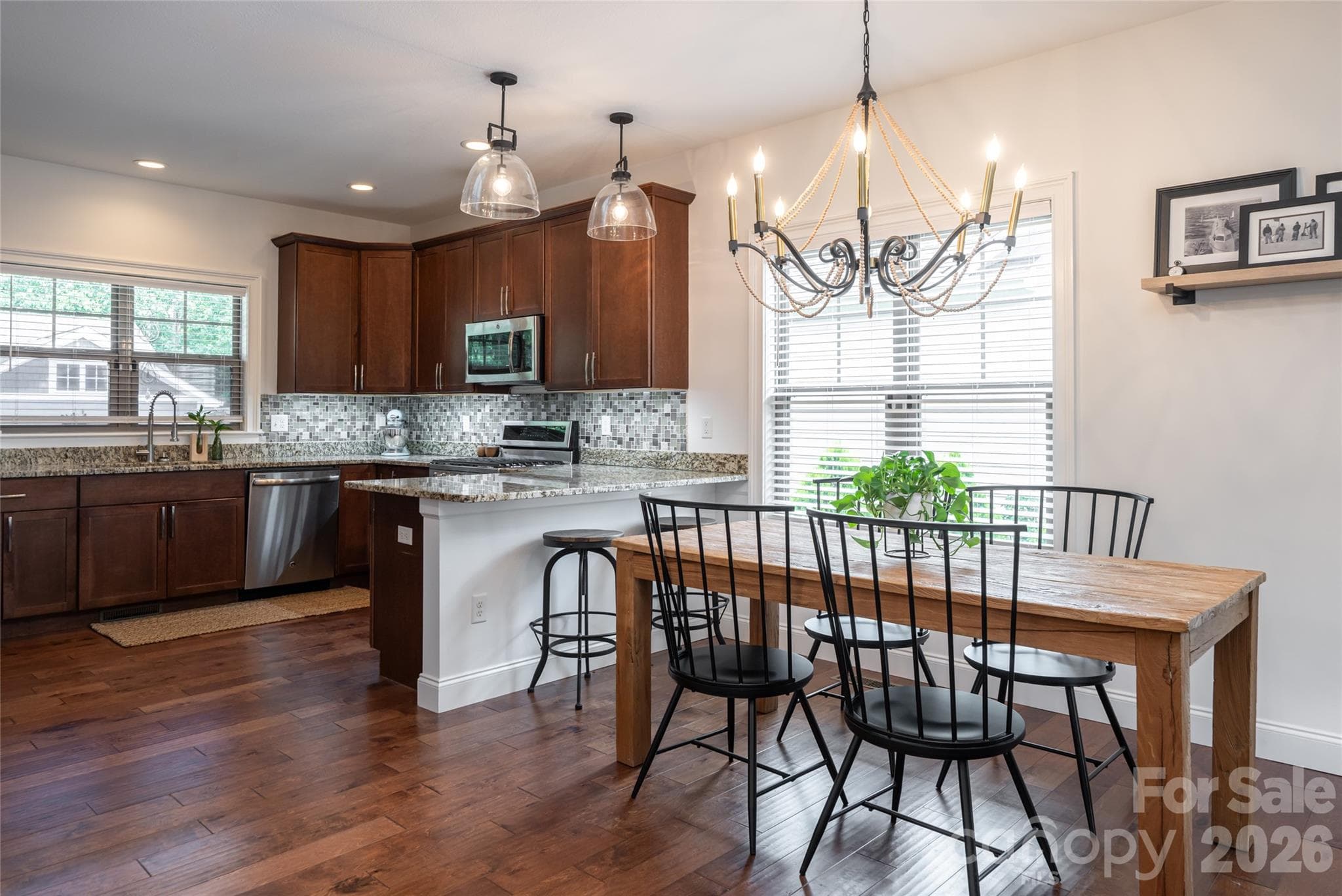 Kitchen and dining area with double windows, granite counters, and space for a full dining table. - 17 Asher Lane, Arden