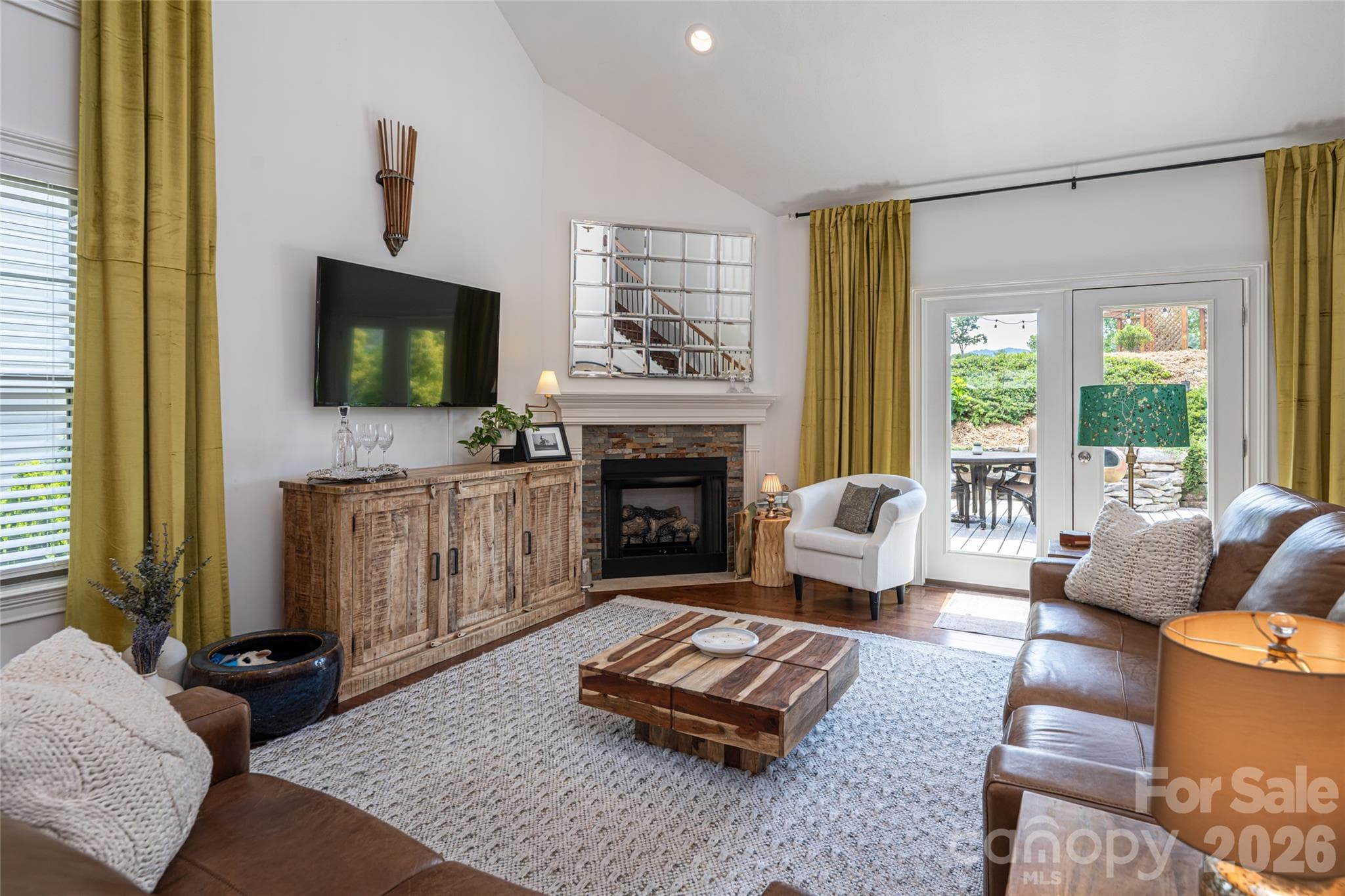 Great room with vaulted ceiling, gas-log fireplace, and abundant natural light from oversized windows. - 17 Asher Lane, Arden