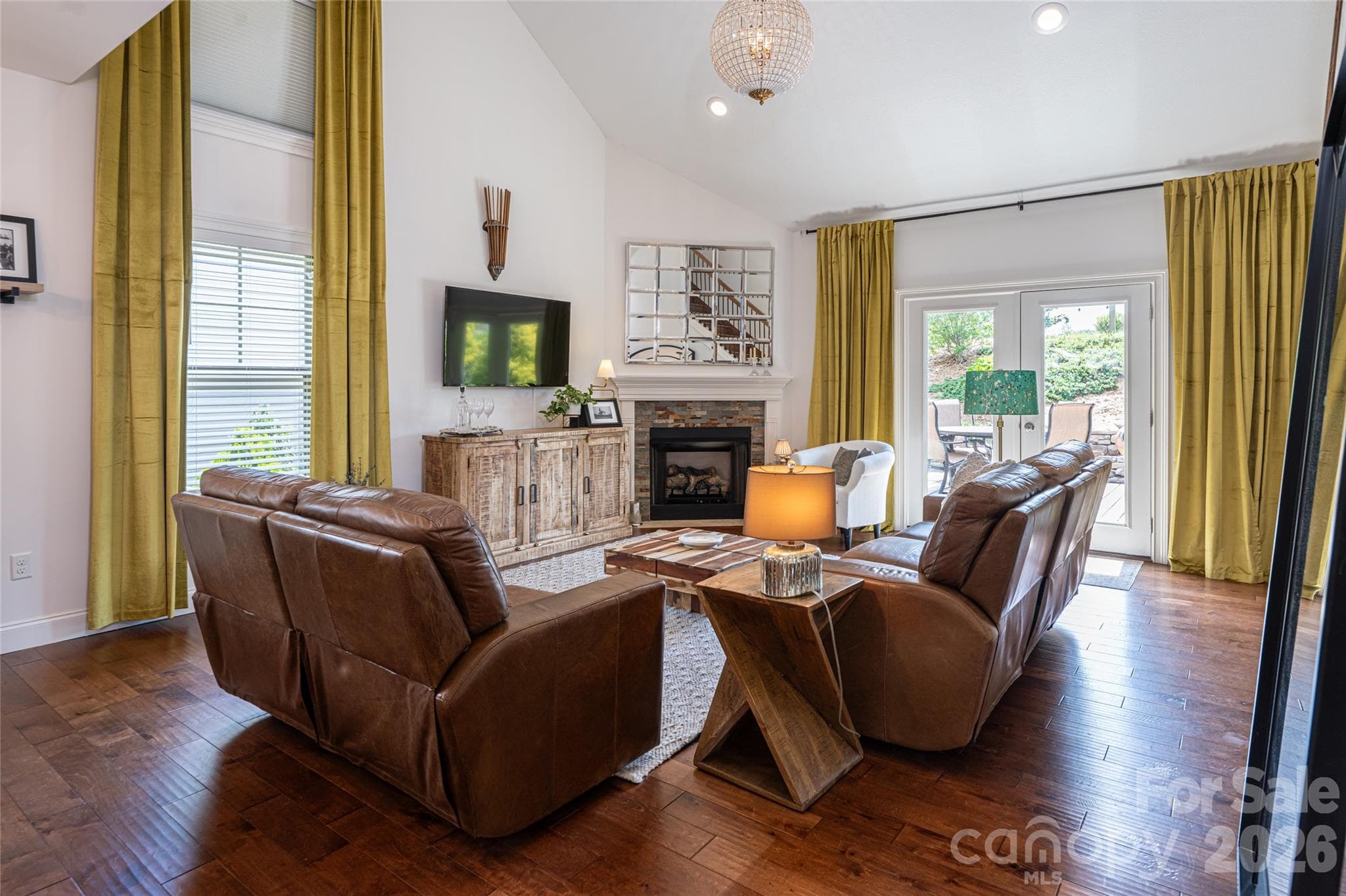 Great room looking toward the fireplace and media wall, showing the open flow of the main level. - 17 Asher Lane, Arden