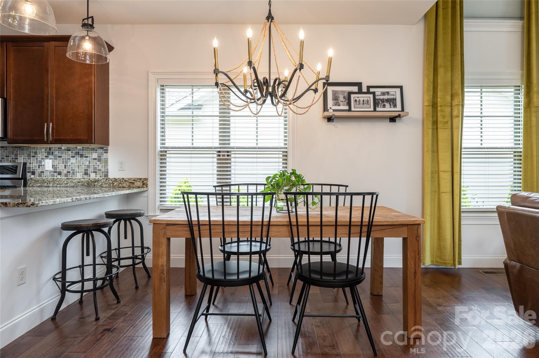 Breakfast bar and dining area adjacent to the kitchen, lit by multiple windows. - 17 Asher Lane, Arden