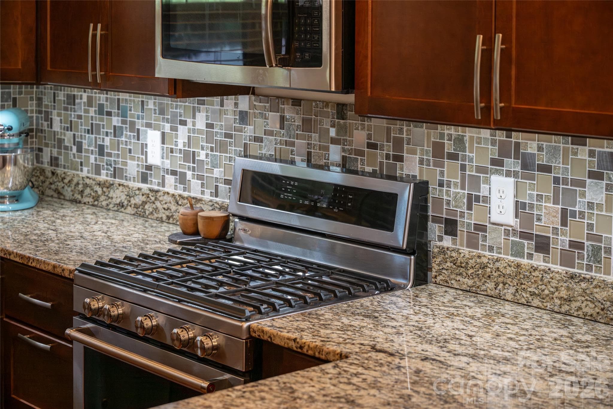 Detail of the gas range, glass-tile backsplash, and granite counters. - 17 Asher Lane, Arden