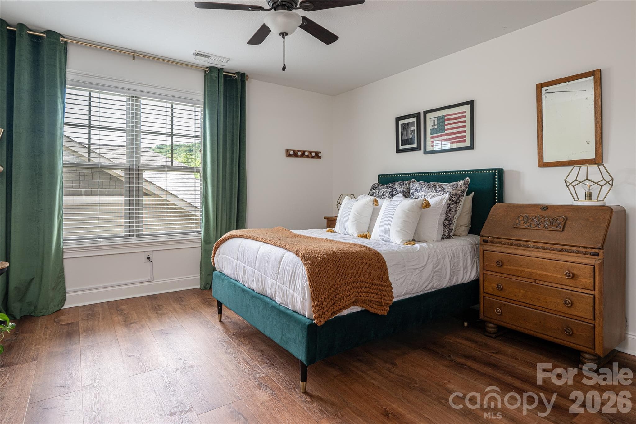 Upstairs bedroom with tall windows, floor-length drapery, and wood-look flooring. - 17 Asher Lane, Arden