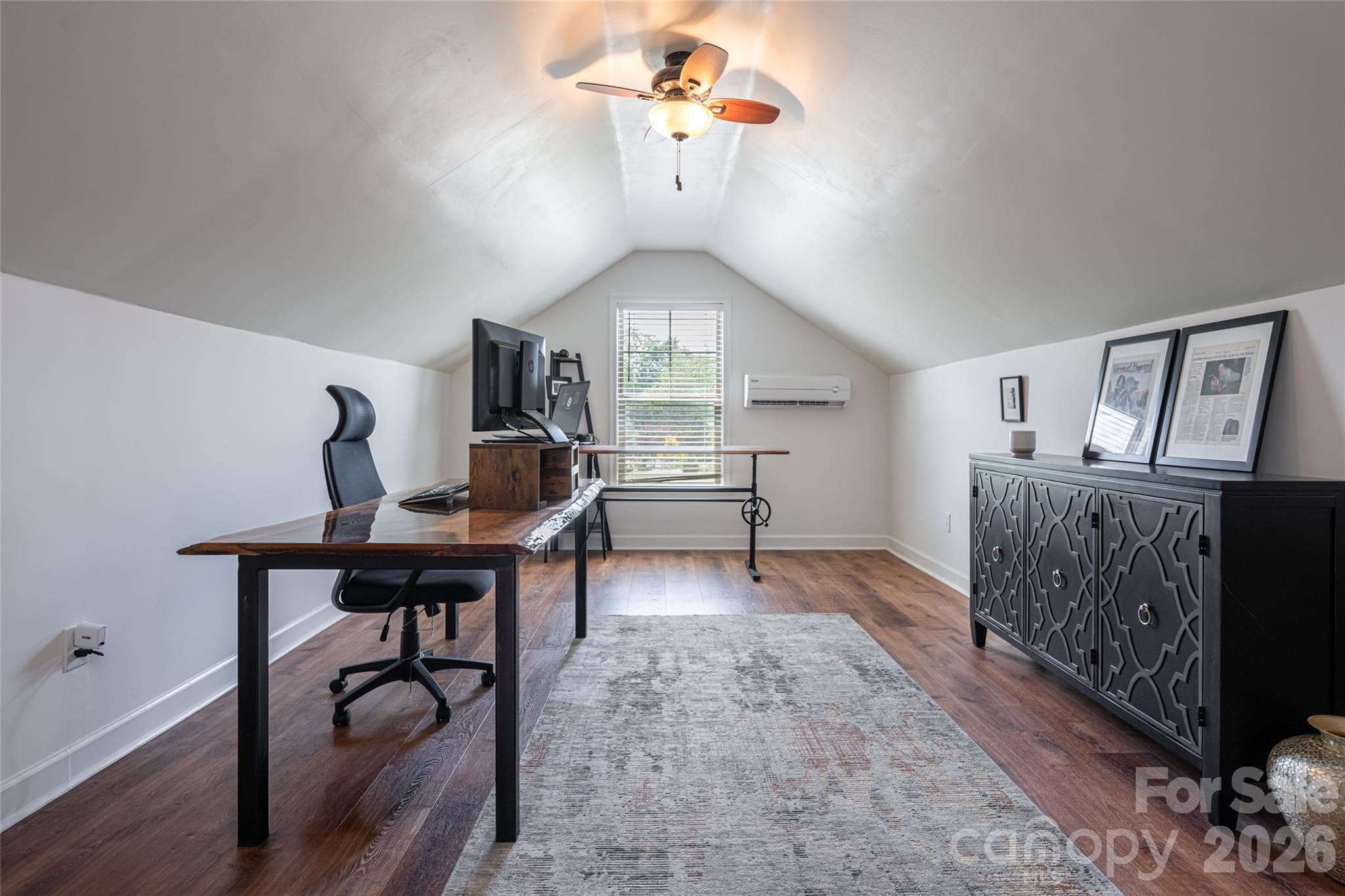 Bonus room configured as a home office, with desk space and vaulted ceiling lines. - 17 Asher Lane, Arden
