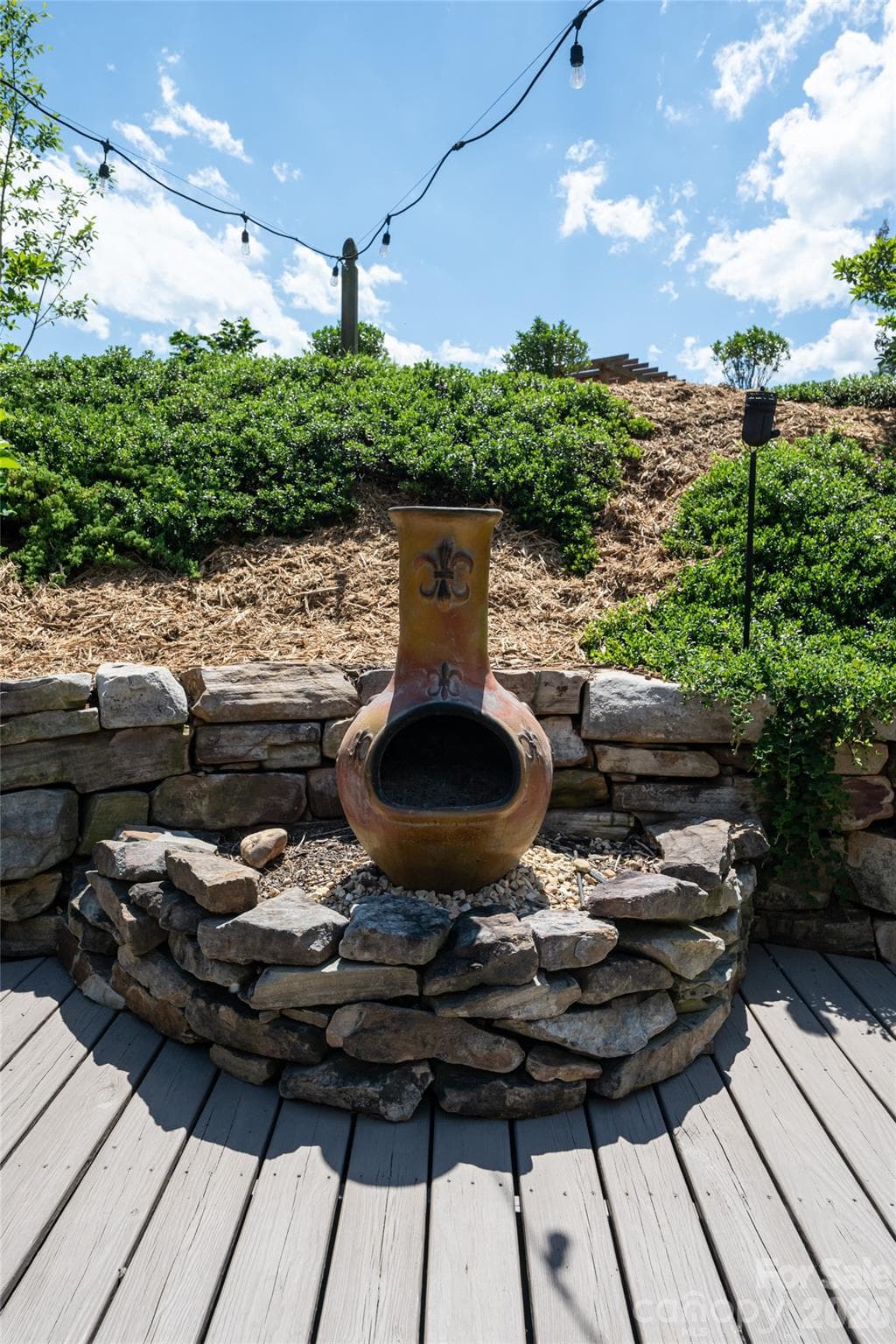 Patio with chiminea fire feature, a defined outdoor gathering spot. - 17 Asher Lane, Arden