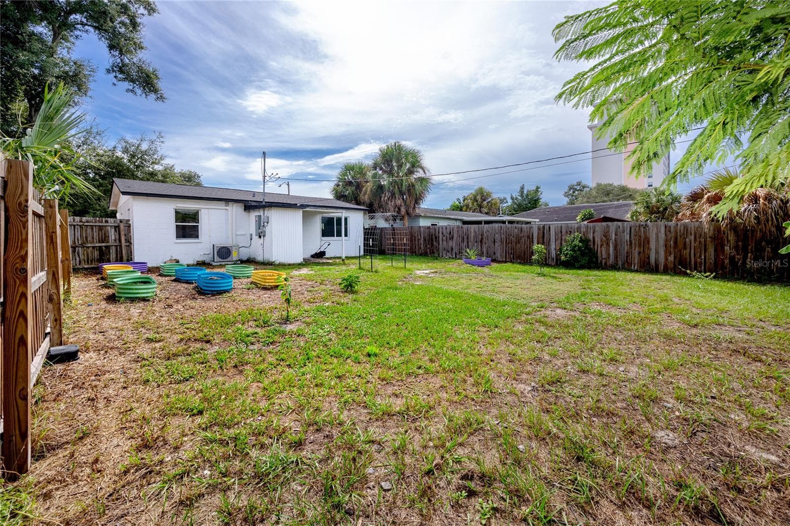 View of the rear of the house with backyard - 5735 BURLINGTON AVE N, ST PETERSBURG