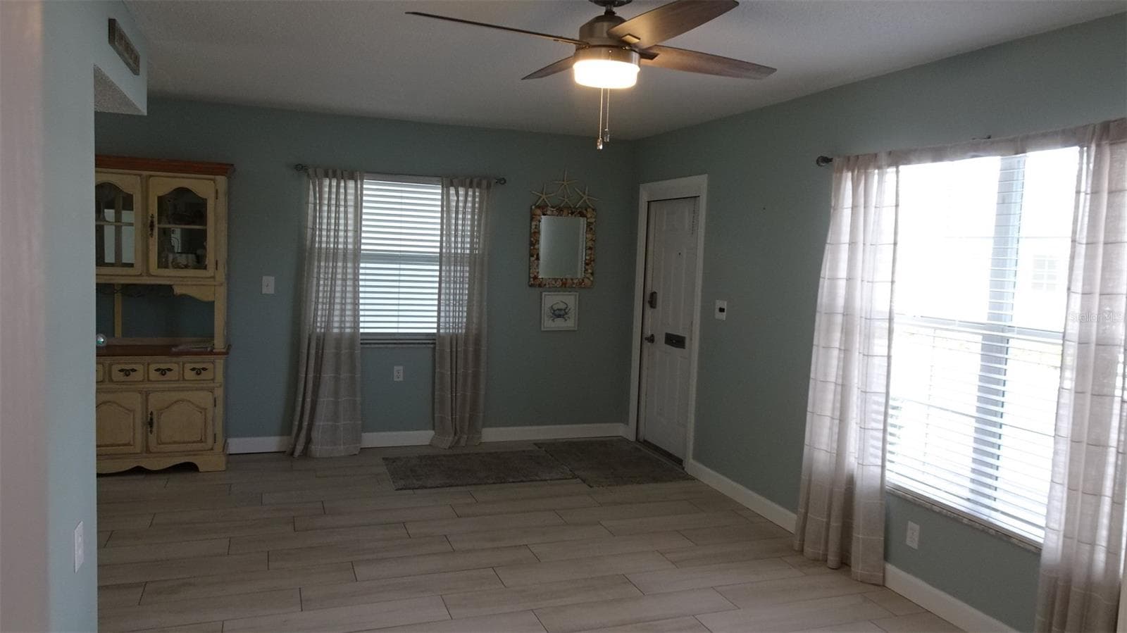 Living room view from hallway. - 7800 38TH TER N, ST PETERSBURG