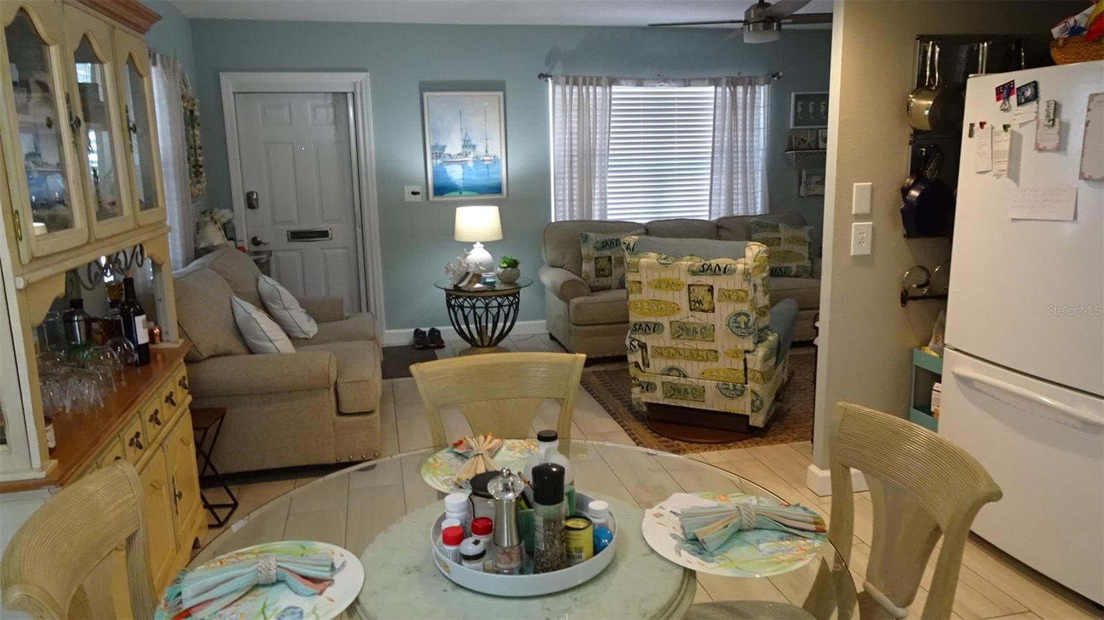 Dining room view into living room as furnished when sellers lived there. - 7800 38TH TER N, ST PETERSBURG