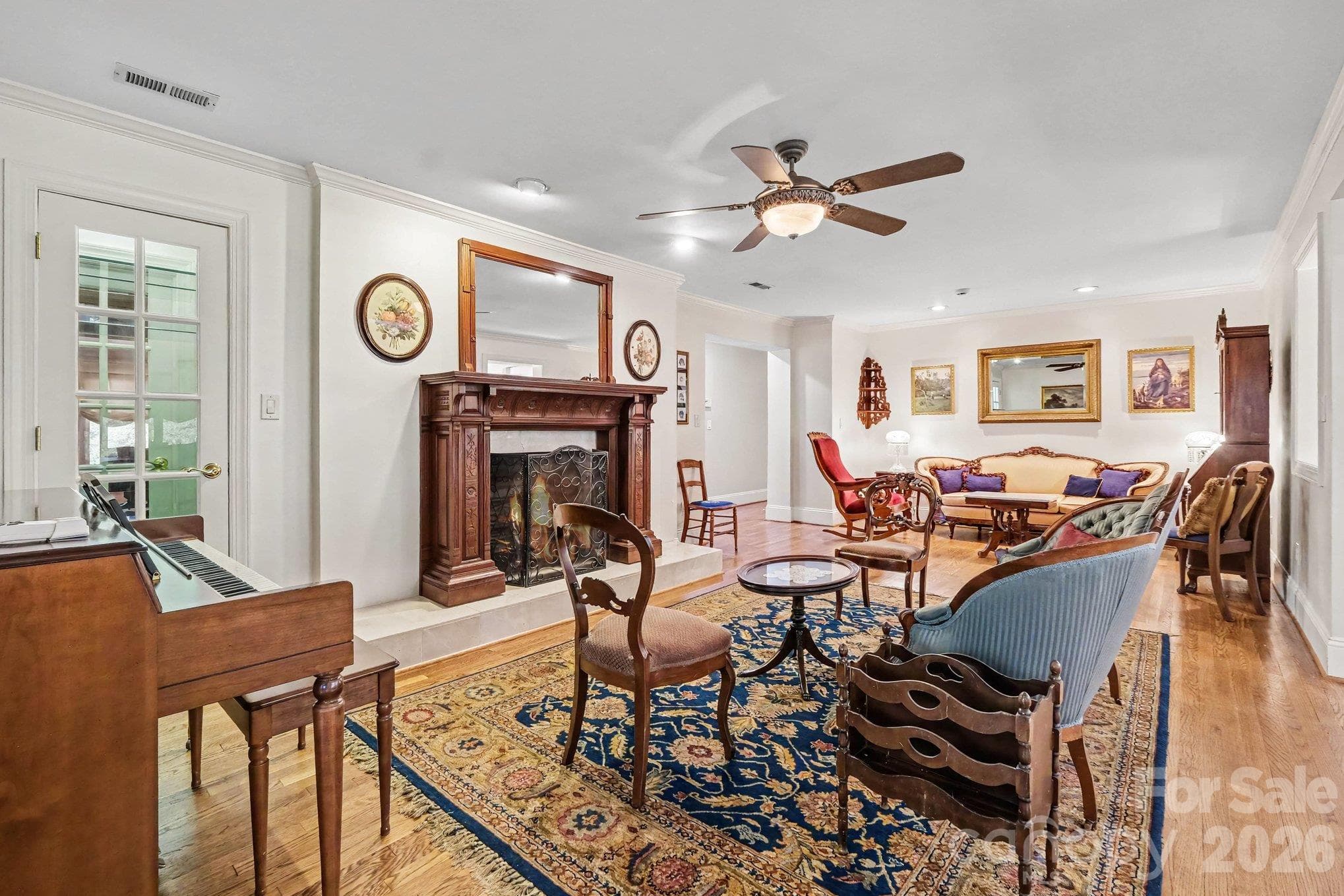 Versatile living/dining/flex area features a display closet and gas fireplace with a beautiful custom mantle - 746 Grandview Drive NE, Concord