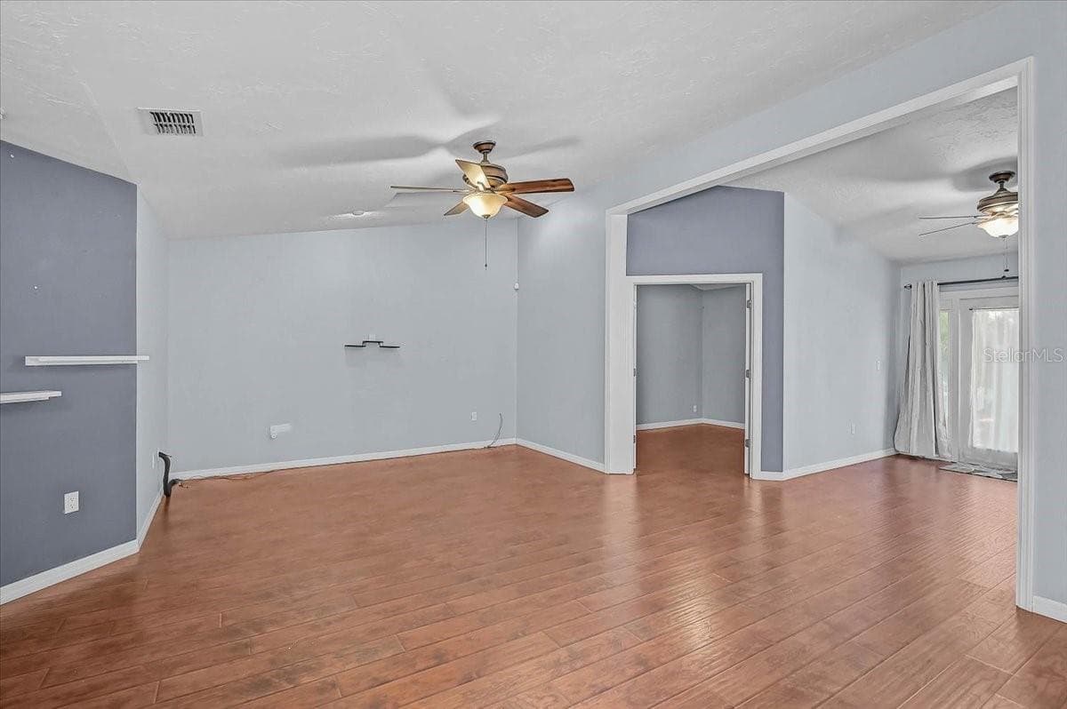 Living Room, Den with Double French Doors, Open Bonus Room to Exterior French Doors to Back Patio and Pond. - 7739 33RD LN E, SARASOTA