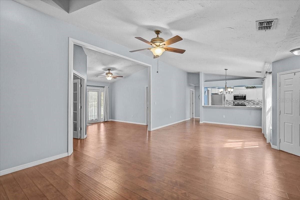 Living Room, Dining Room, Kitchen, Den with Double French Doors, Open Bonus Room to Exterior French Doors to Back Patio and Pond. - 7739 33RD LN E, SARASOTA