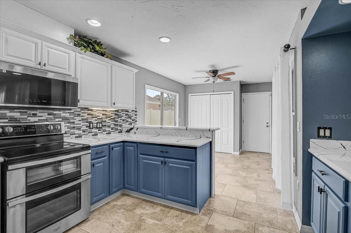 Kitchen Looking into Dinette and Sliding Glass Doors to Side Patio, - 7739 33RD LN E, SARASOTA